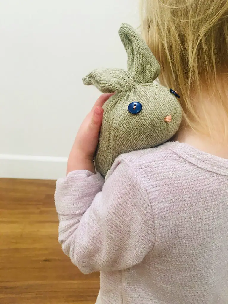 toddler holding sock bunny