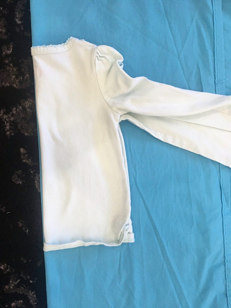 measure a shirt on blue fabric