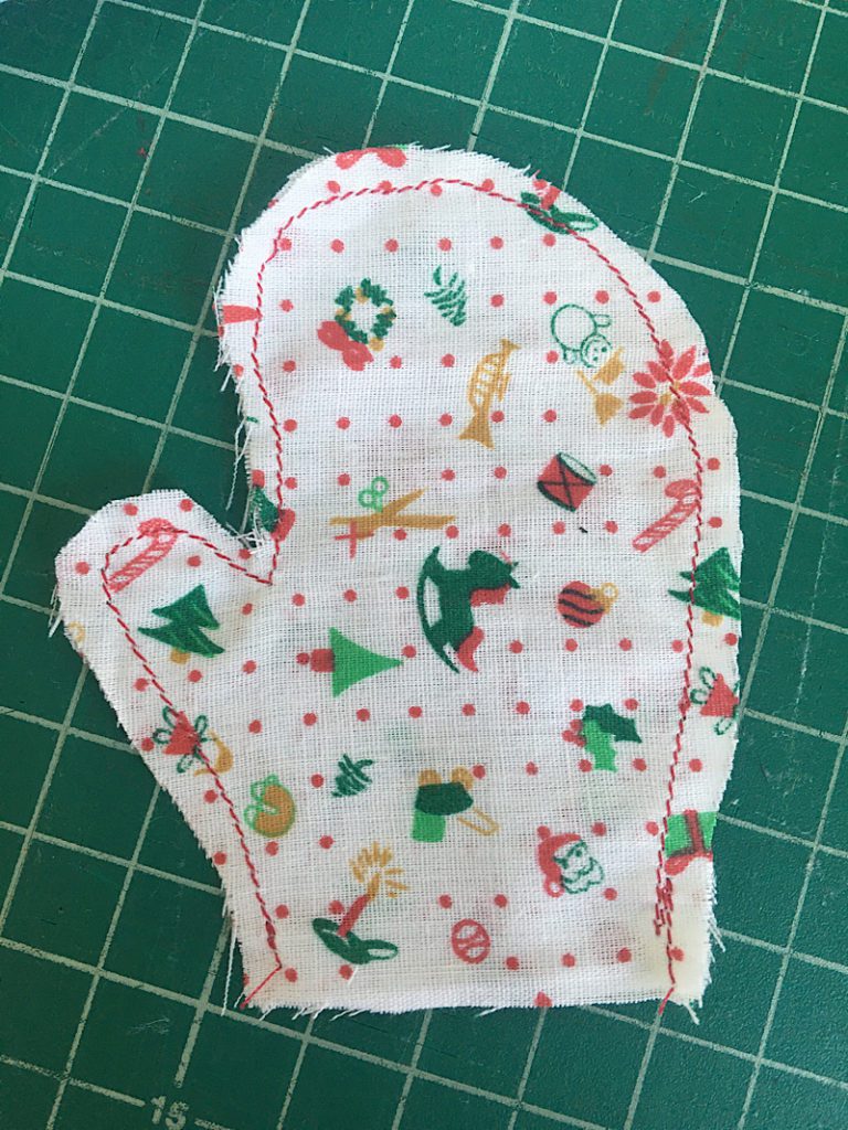 Stitched line around mitten