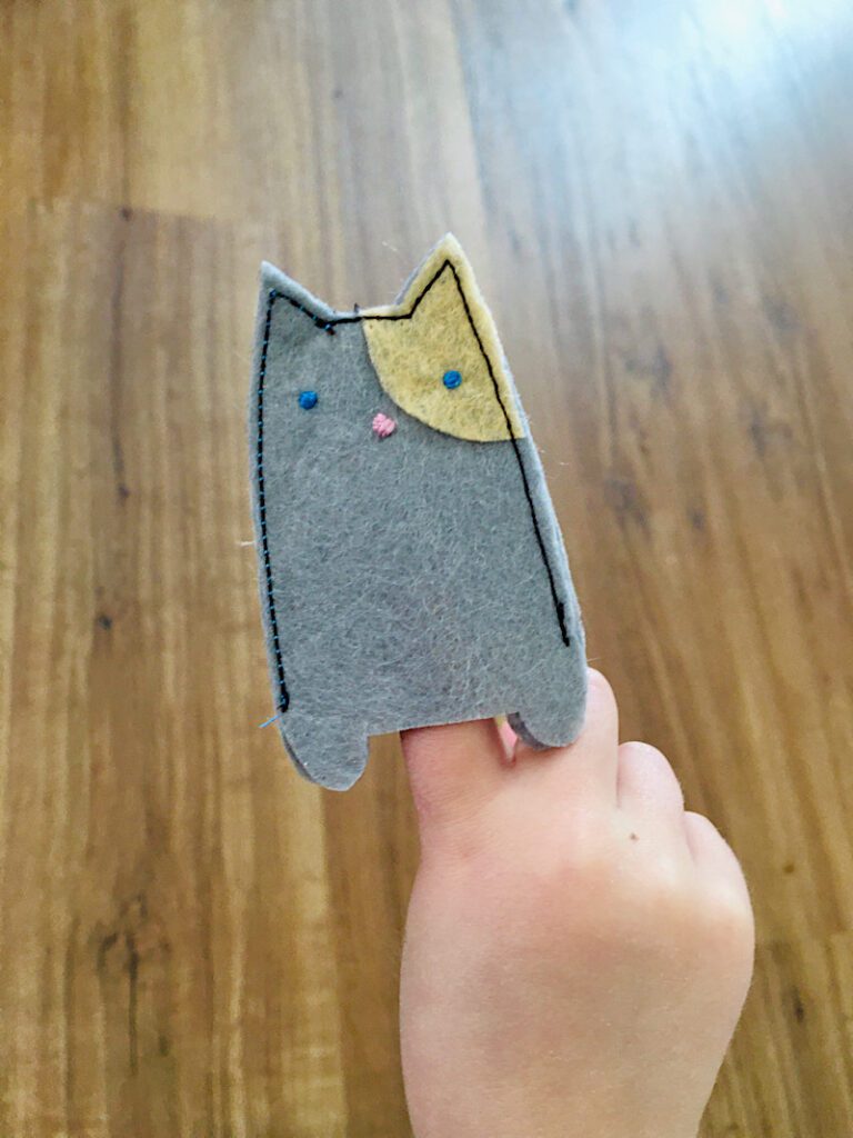 felt finger puppet cat on childs finger
