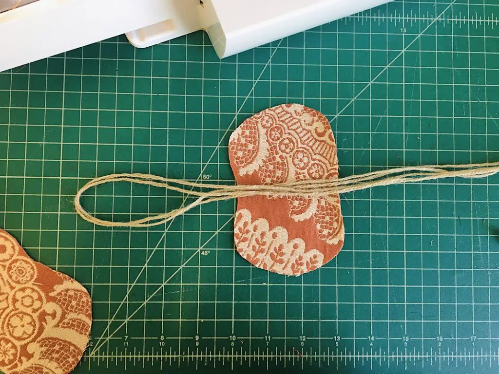 lay the string on top of the fabric pumpkin shape