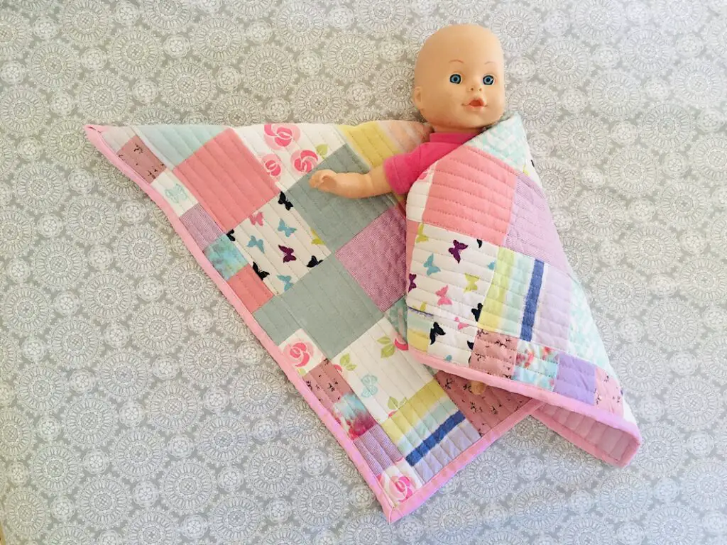 baby quilt with doll