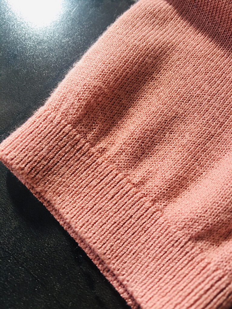 pink knitted sweater arm 