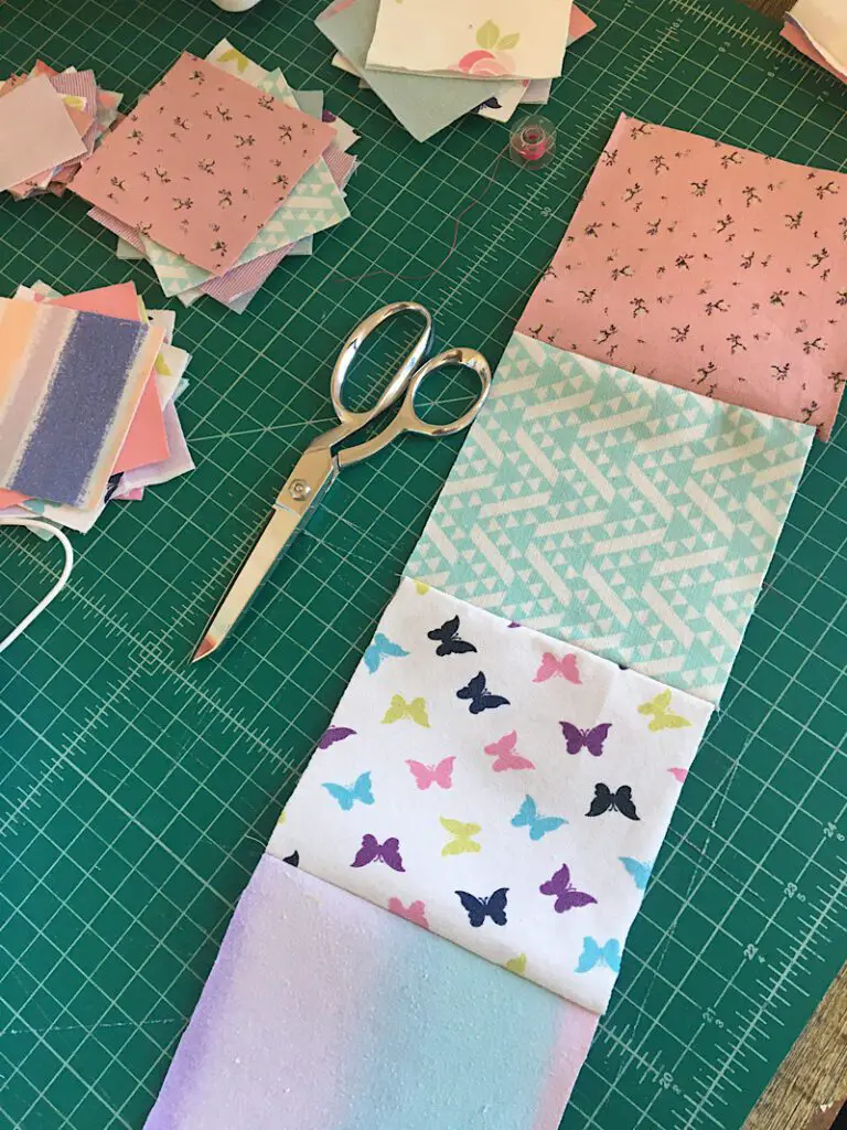 sewing together the baby quilt blocks