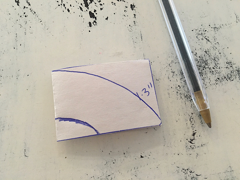 drawing the handle shape on the folded paper