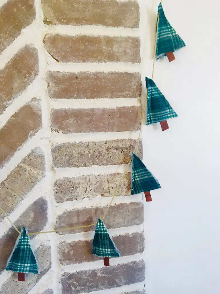Christmas tree bunting hanging over bricks