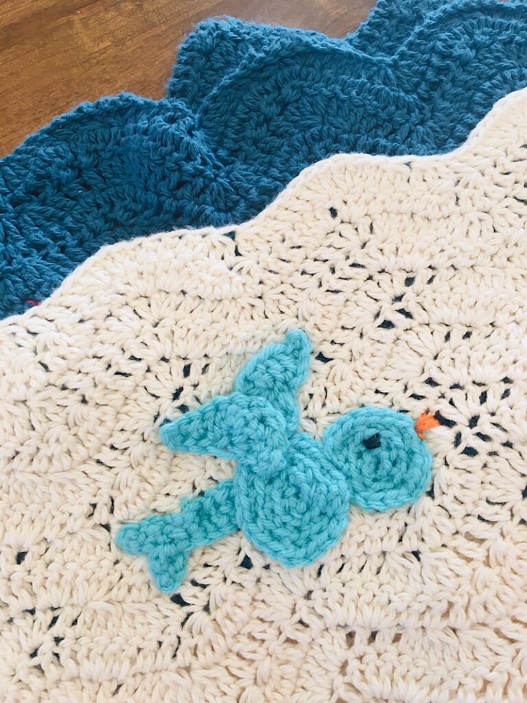 closeup of crochet afghan with bird