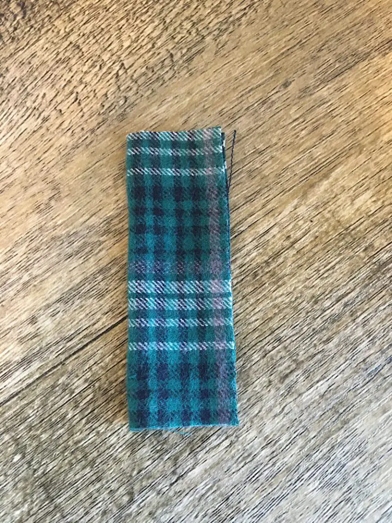 folded piece of green plaid fabric