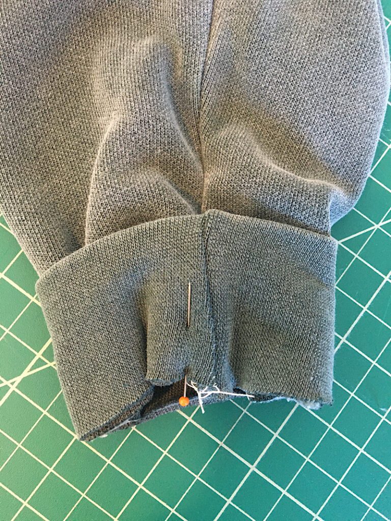 pinning the tighter cuff back onto the sleeve