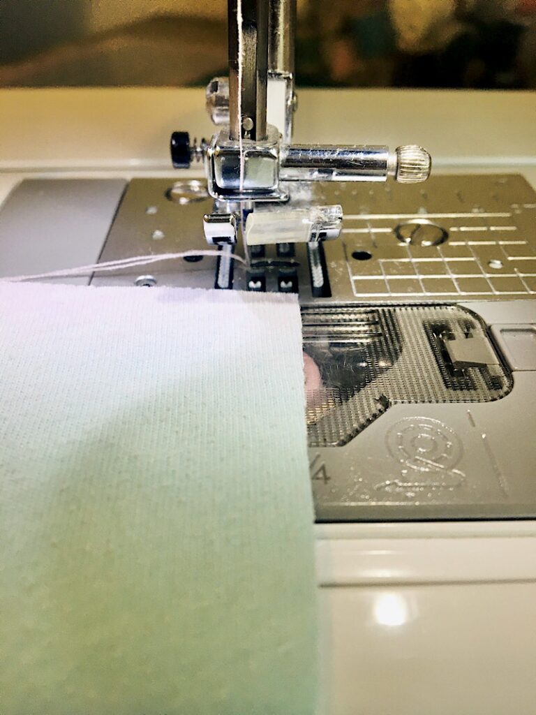 Fabric on sewing machine to the left