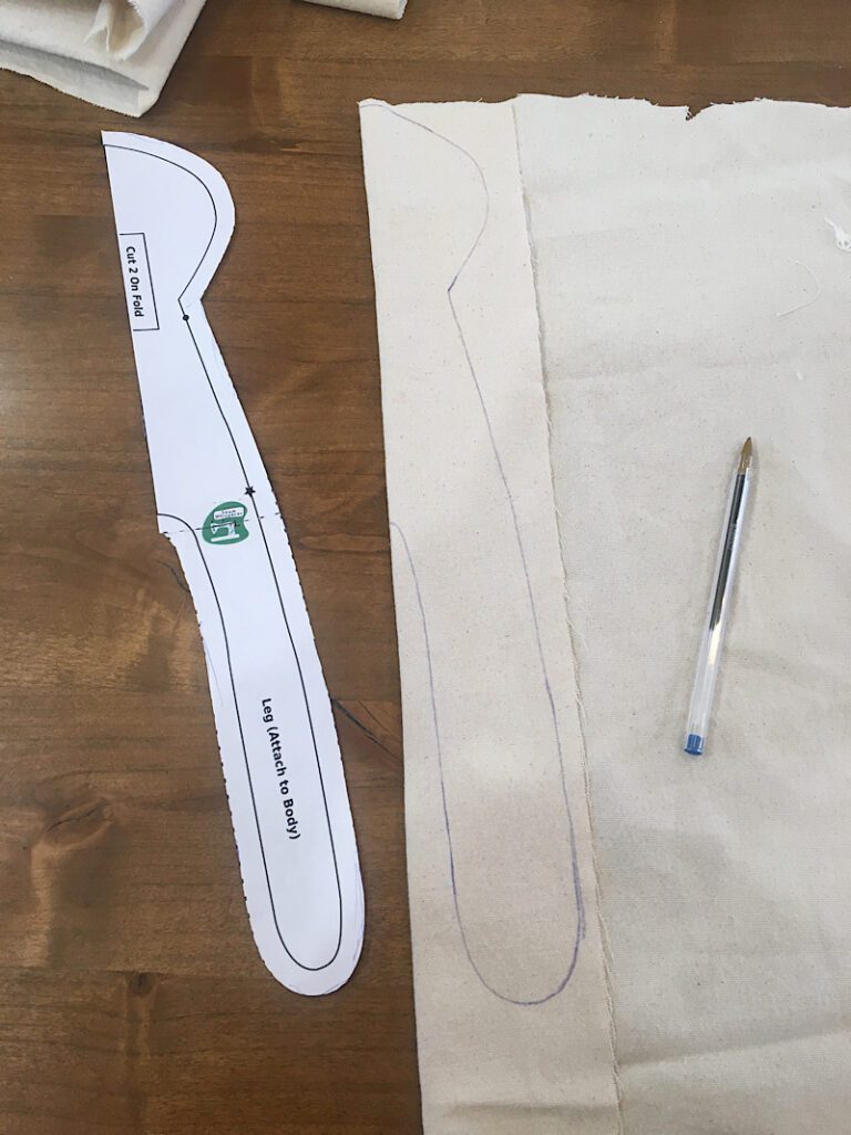 trace the cloth doll body pattern onto fabric with a pen