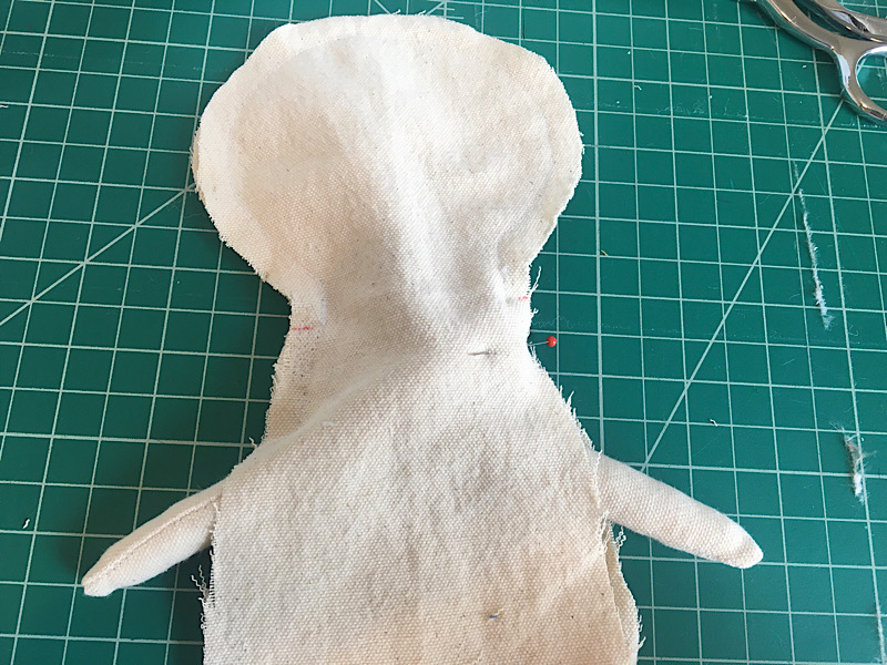 both doll arms sewn into the doll