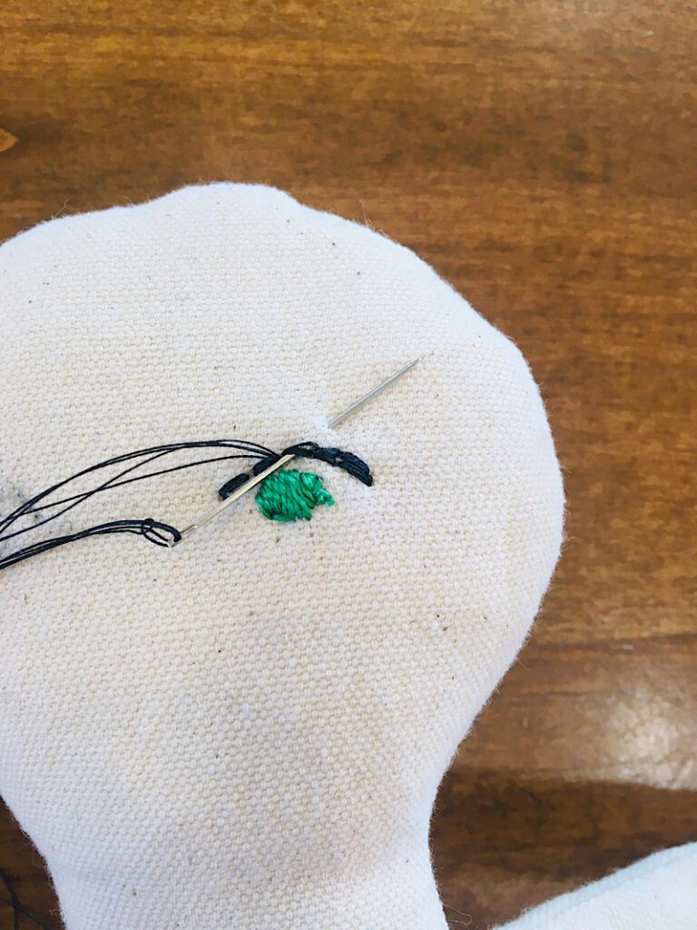 backstitching back to the center of the eyelid