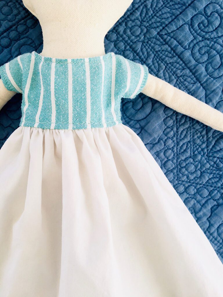 close up of rag doll dress DIY blue stripes with white skirt
