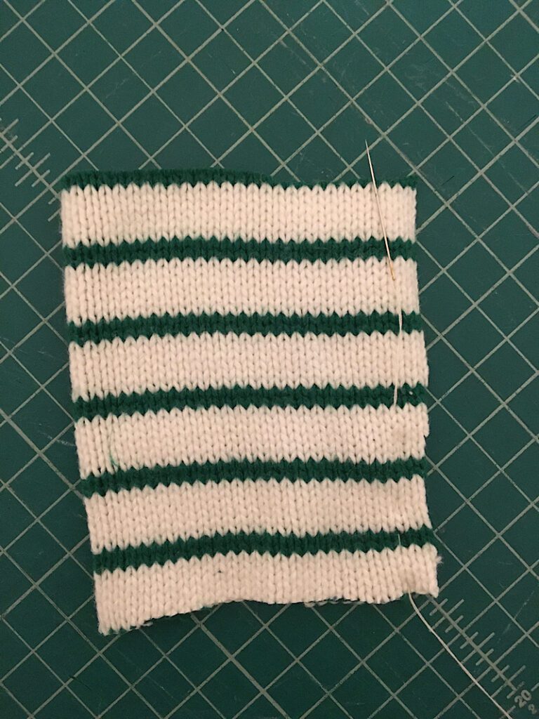Sewing down the side of the folded sweater