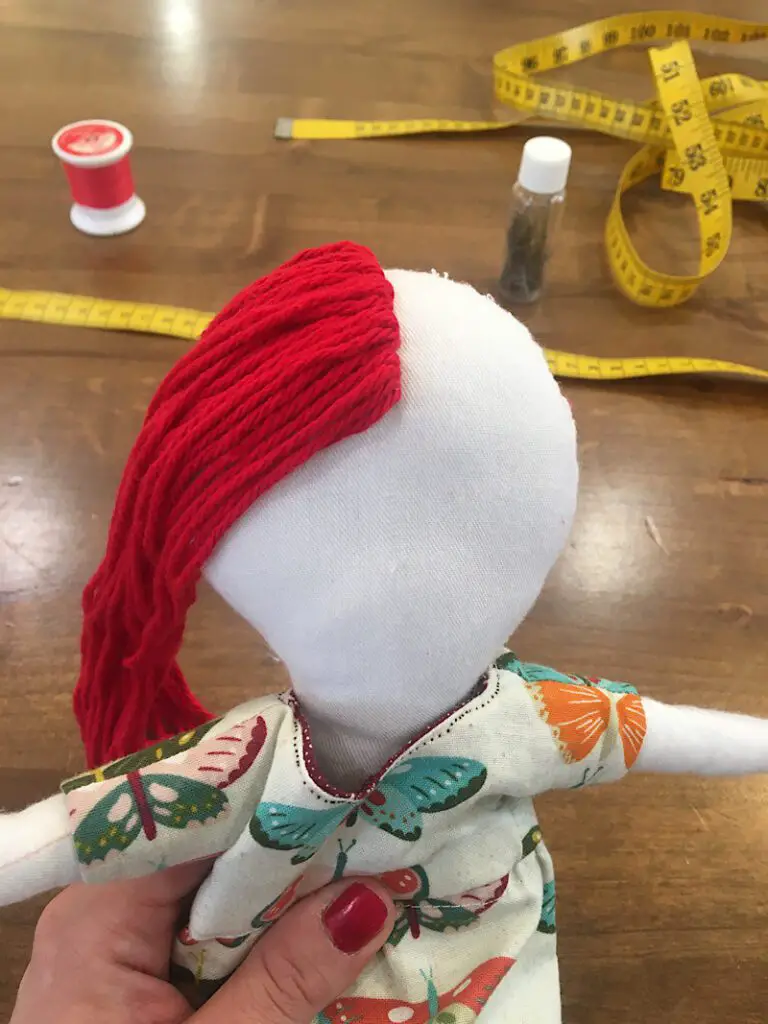 yarn doll hair on left side of face