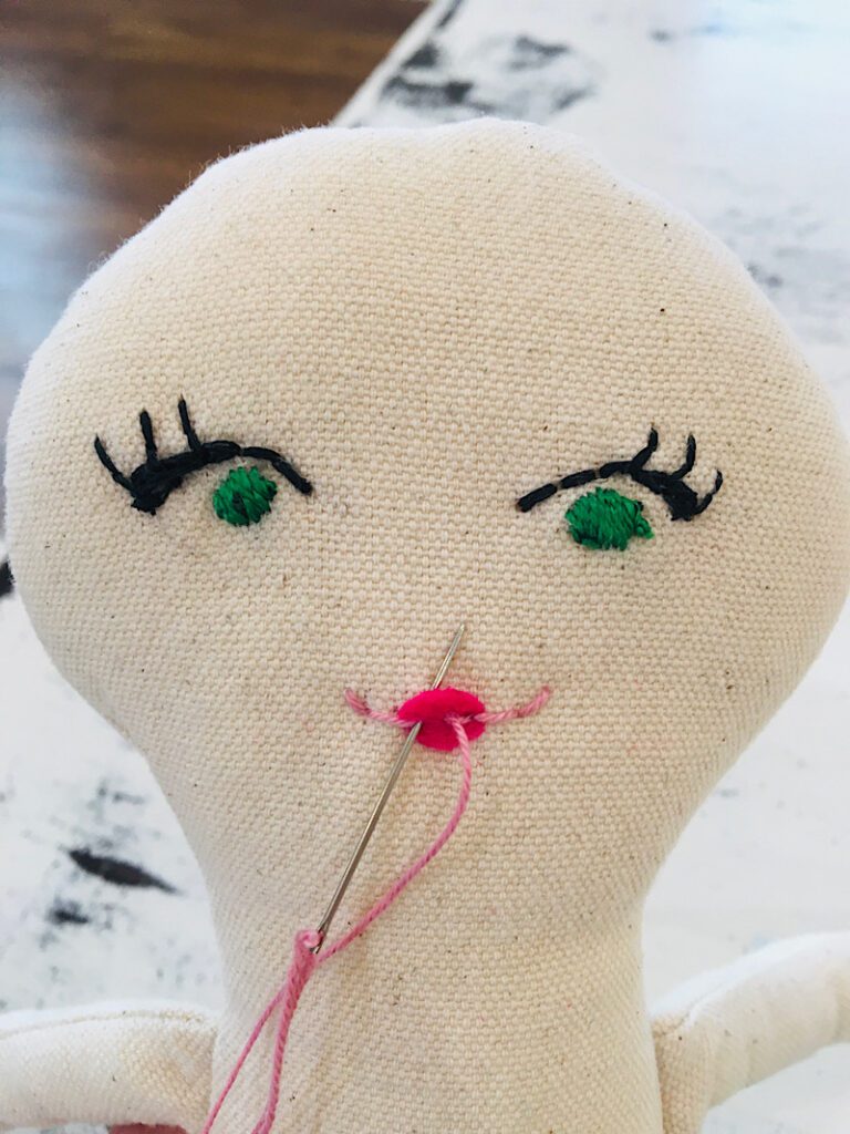 finishing the mouth and lips of the cloth doll