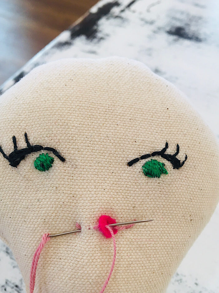 left side of rag doll mouth stitches