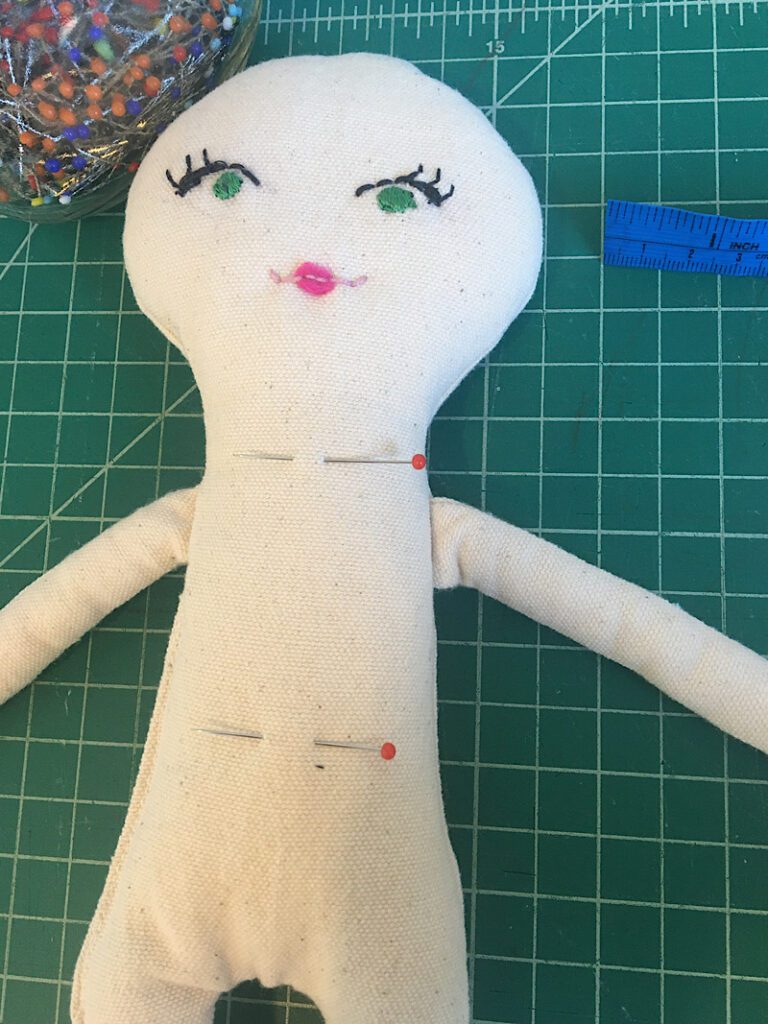 pins on rag doll marking waist