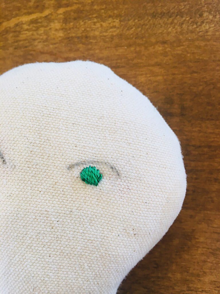 finished iris green embroidery thread on doll