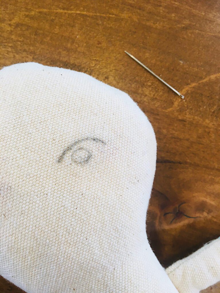 Eye shape drawn on doll before embroidering