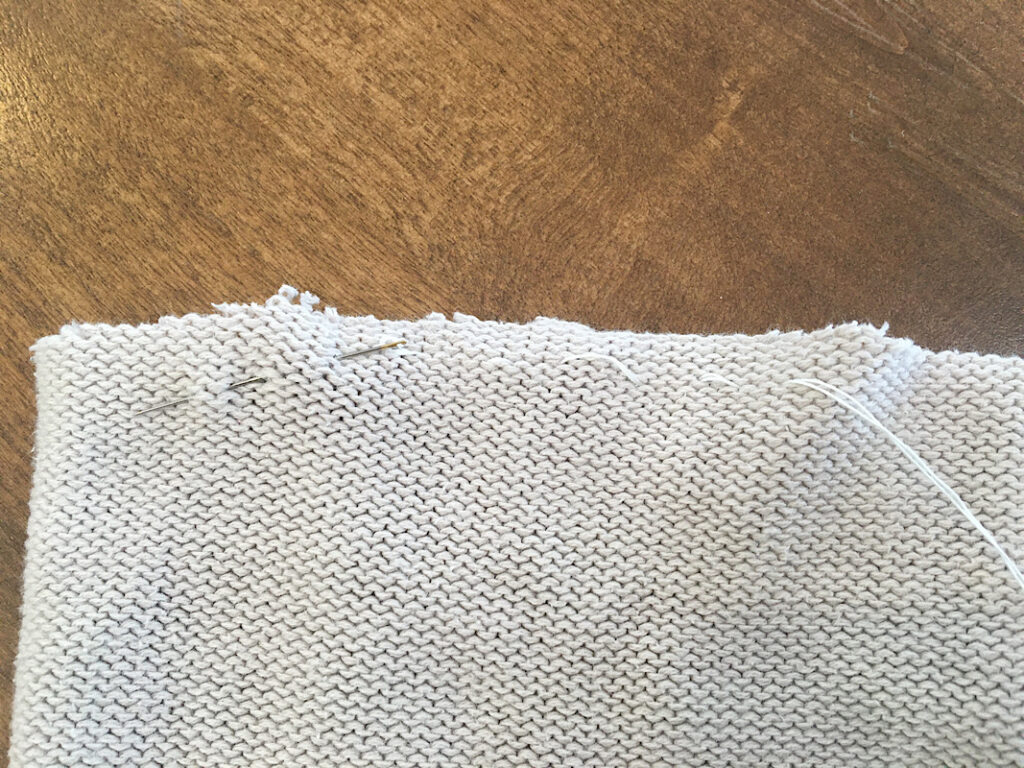 sewing a running stitch on sweater