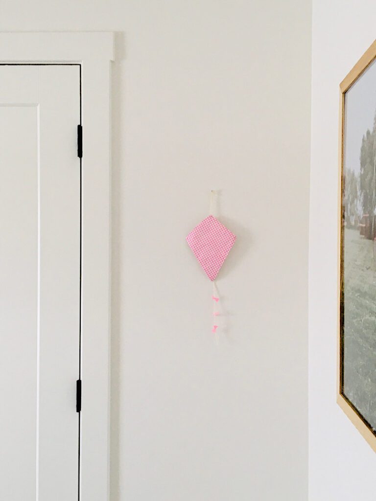 pink decoration kite hanging on child's wall