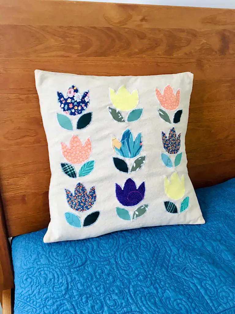 DIY Tulip Pillow Cover applique made from ties on bed blue