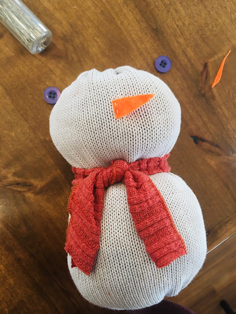 sew the nose on snowman