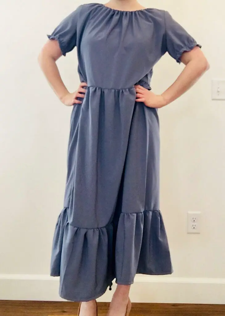 Woman wearing a blue peasant dress with a ruffle skirt