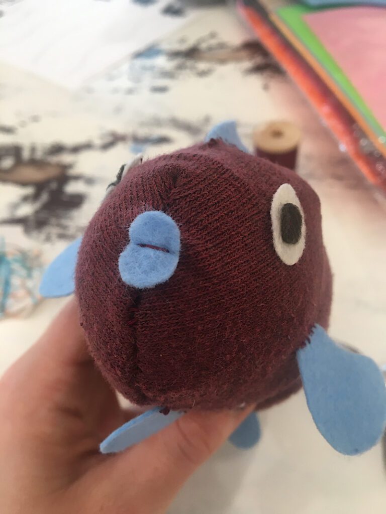 sewing lips on a sock fish