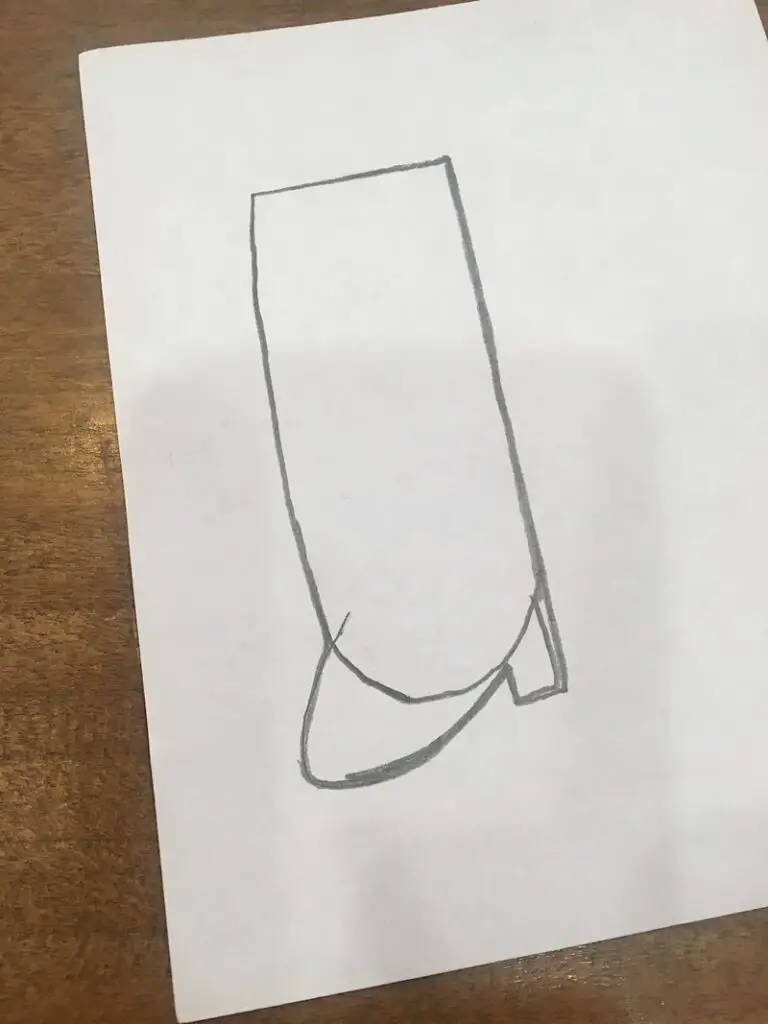 drawing a boot shape on the paper