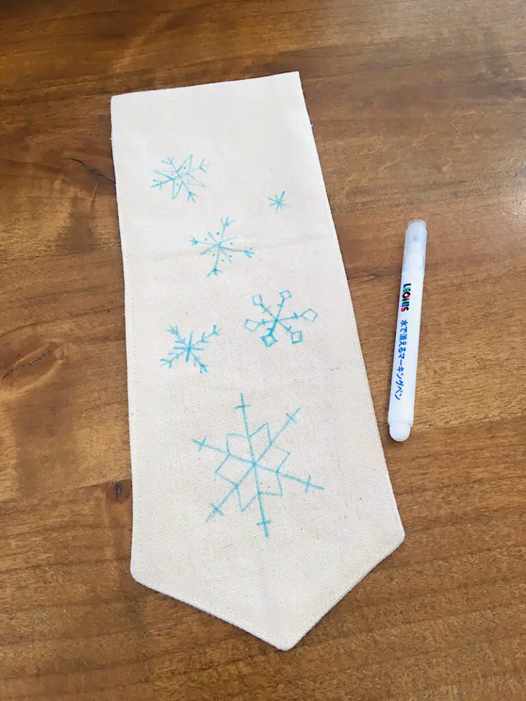 Draw snowflakes around the banner door hanger