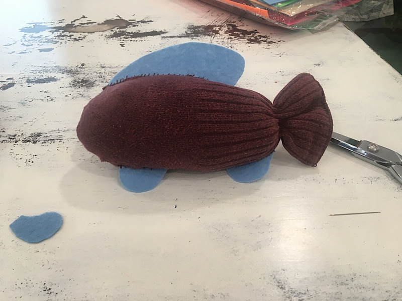 sewing the fins on a sock fish