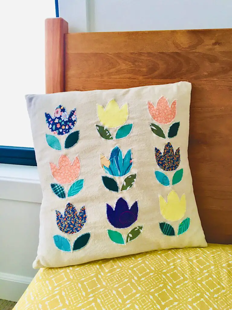 DIY Tulip Pillow Cover applique made from ties on bed