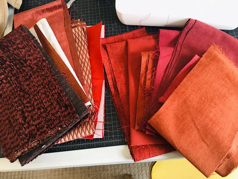 Many samples of different red upholstery fabrics