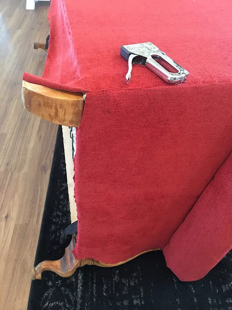 stapling the back piece to the couch