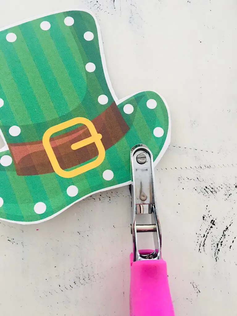 hole puncher punching  holes in leprechaun hat sewing card