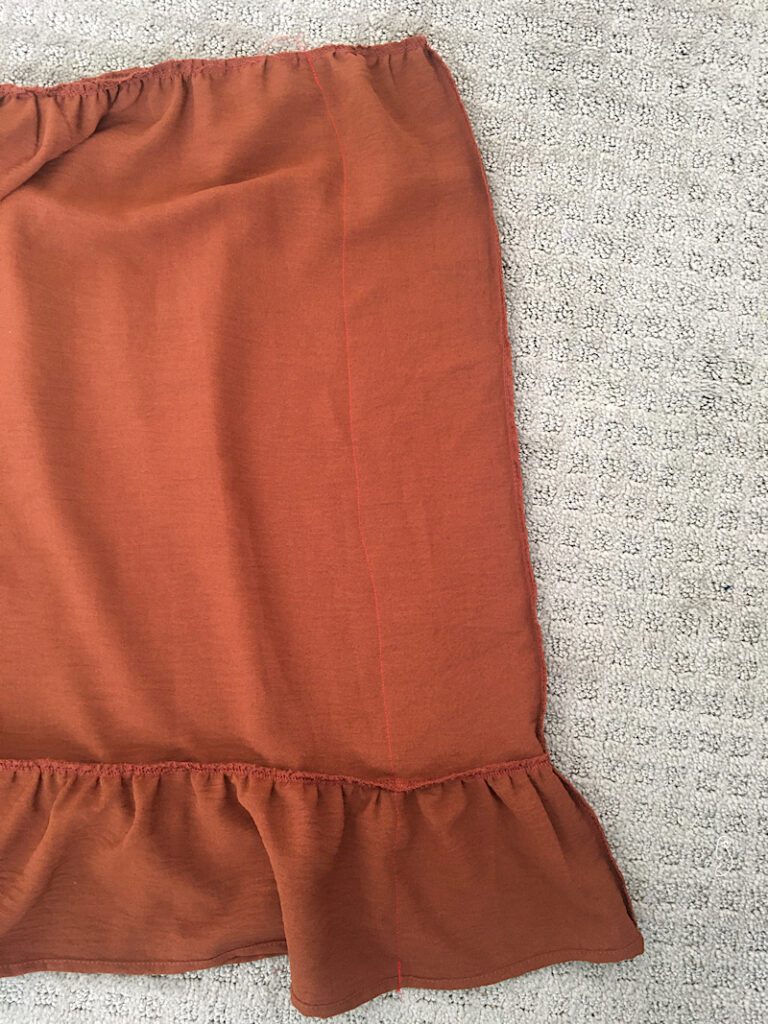 sewing a line down the seam of a skirt