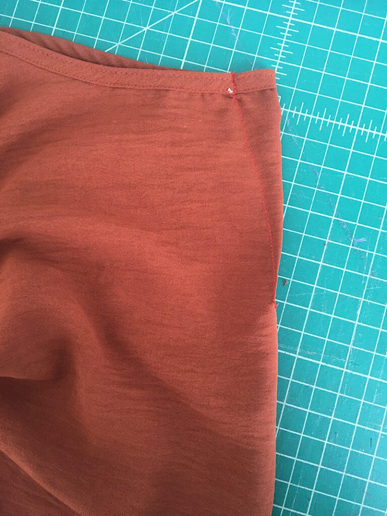 sewing a little dart to make a dress smaller