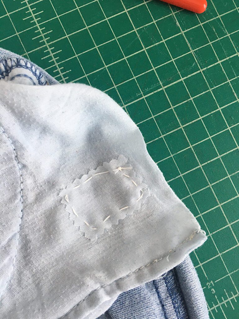 patching a hole in jeans front pocket with scrap