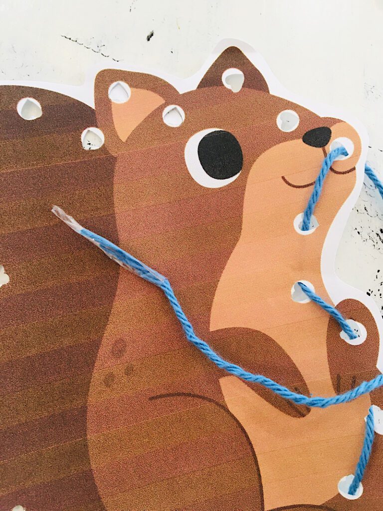 tape the end of a string on a squirrel lacing card