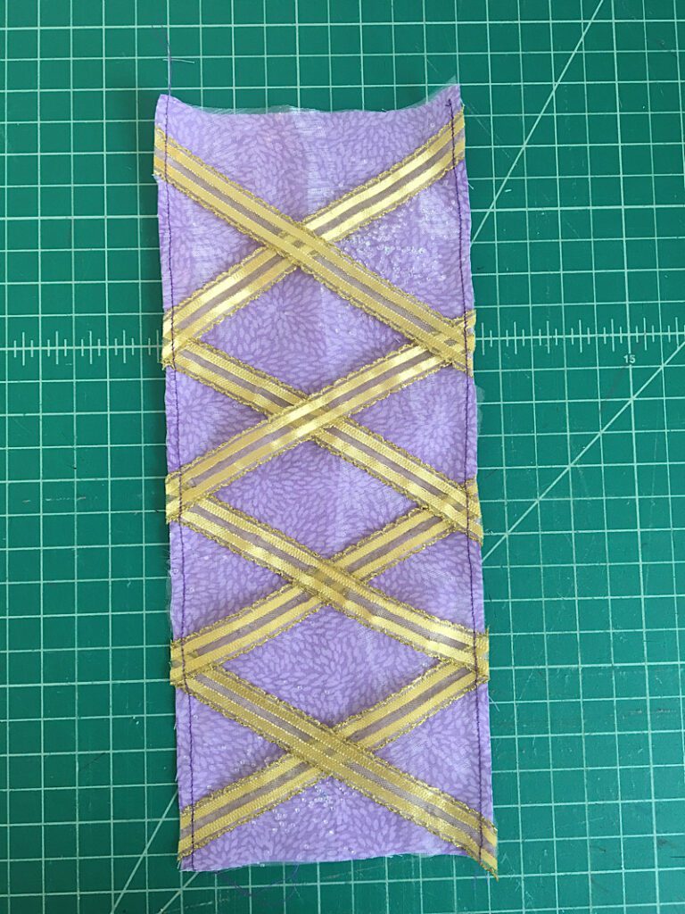 sewing the panel with the ribbons