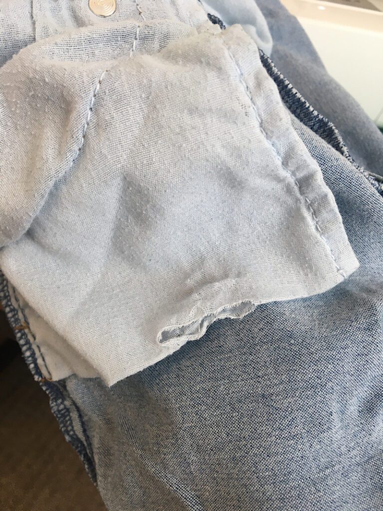 a hole on the bottom edge of jeans front pocket