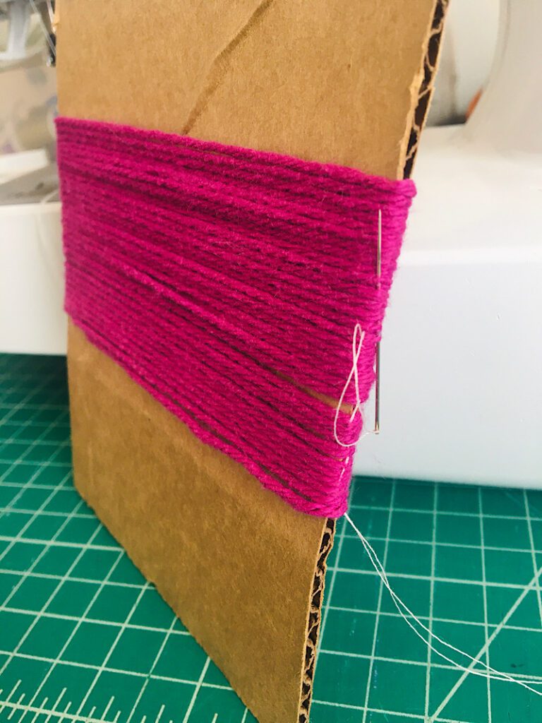 stitching the side of wound yarn for doll hair