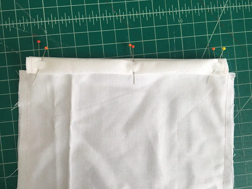 folding and pinning the top edge of the bunny bag