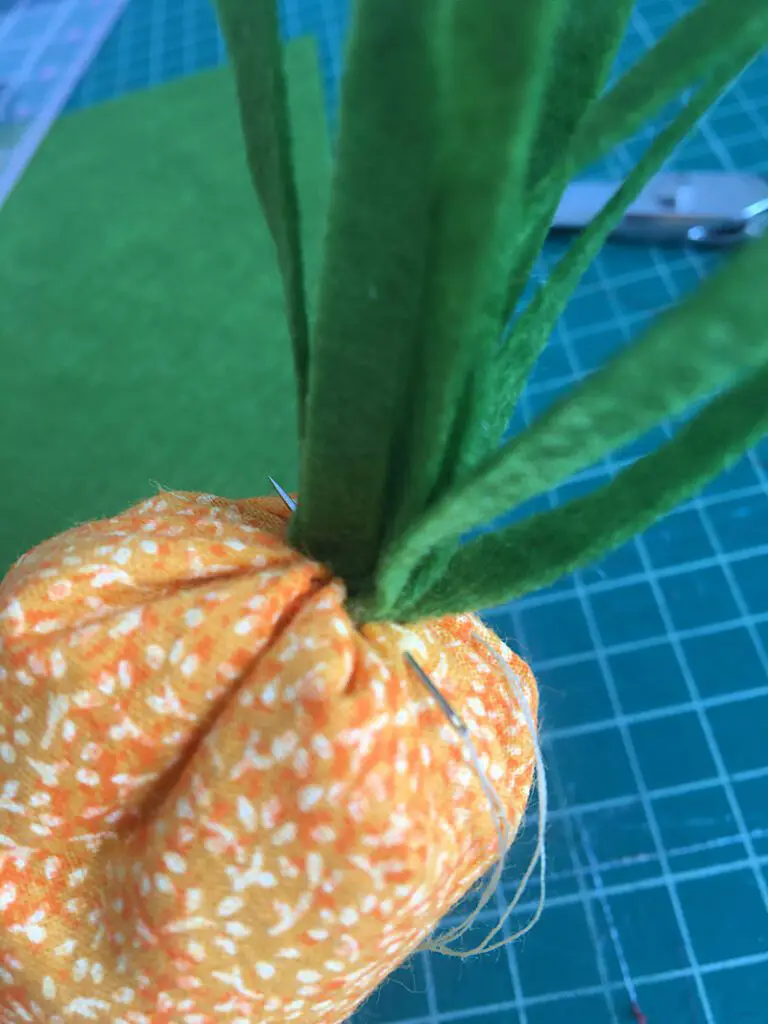 sewing leaves to carrot