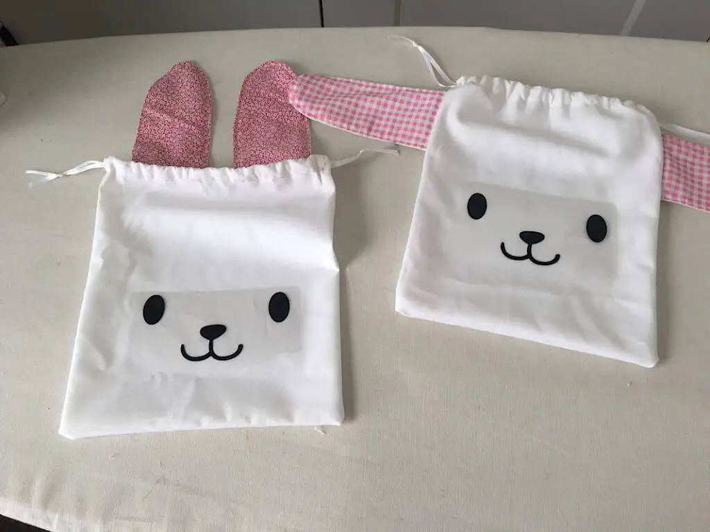 Ironing on the bunny faces to the drawstring bags