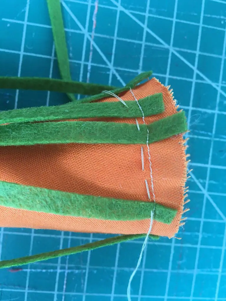 sewing a basting stitch to close the carrot