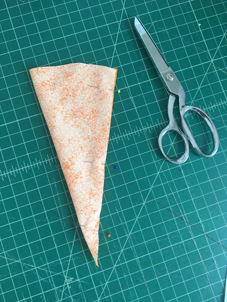 Pin down the side of the fabric carrot